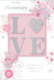This anniversary card design evokes the feeling of a softly spoken promise, the kind a couple might share after an evening stroll through Forest Gate's tree-lined streets. At its heart, the word LOVE stands proudly in capital letters, each one raised from the card's surface and dusted with a smooth layer of soft pink and pearlescent glitter. The letter O is subtly suggested as a gentle heart shape, shimmering with silver accents that glint like jewellery under candlelight. This tactile centrepiece rests on a background of muted pastel pink, with lighter and darker tones blending together to create a gentle, cloud-like glow. Encircling the central word is an arrangement of delicate, illustrated flowers and swaying foliage, their petals tinted in blush, mauve, ivory, and hints of lilac. Fine, swirling lines sketch leaves and tendrils, giving the impression of a hand-drawn bouquet, much as a local Forest Gate florist might plan an anniversary arrangement before choosing the freshest stems from nearby markets. Tiny details-petals caught mid-fall, graceful curls, and discreet butterfly shapes-add a sense of motion, as if a light breeze has passed across an English spring garden. Throughout the card, subtle touches of silvery grey and metallic accents highlight key details, providing a gentle shimmer without overwhelming the calm, romantic palette. Elegant script phrases, including On Our Anniversary and I love you today and always, are written in a refined, flowing style that mirrors the curves of the blooms. The overall impression is intimate and heartfelt, a paper equivalent of a tender bouquet designed to celebrate the journey of two people who continue choosing each other, day after day.